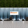 Stunning Waterfall Water Wall With Lush Green Backdrop Decorative Smooth Stones And Lighted Tiled Floor