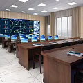 Control Room Interior Setup With Large Monitoring Screen Multiple Computer Monitors And Desks