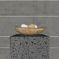 Fresh Eggs in a Straw Nest on a Speckled Gray Stone Pedestal Against Gray Wall