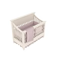 White Baby Crib With Purple Bows Striped Blanket And Ruffled Skirt