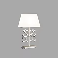 Elegant Table Lamp With White Fabric Shade And Intricate Metal Base Design