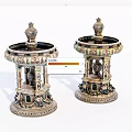 Two Decorative Vessels With Intricate Carvings Detailed Patterns And Gold Accents