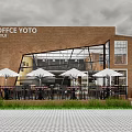Coffee YOTO Storefront With Brick Building Large Glass Windows Outdoor Seating White Umbrellas And Greenery
