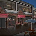 Charming Commercial Street With Red Brick Buildings Red Awnings Outdoor Seating And Wooden Deck
