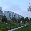Modern Multi Story Residential Building With Gray Exterior Lawn Trees Pathways And Street Lamps