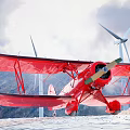 Red Biplane Passenger Plane with Wind Turbines and Mountains in Cloudy Sky