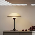 Modern Table Lamp With Red Fruits In Bowl On Cabinet White Wall Background