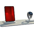 Red Black Smartphone and Silver Smartwatch Digital Products on Display Stand with Charging Cable