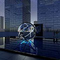 Spherical Sculpture Featuring Blue Lighting In Urban Water Pool Near Skyscraper Buildings