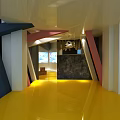 Modern Restaurant Interior Featuring Geometric Structures Yellow Floor And Colorful Pillars
