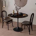 Modern Round Dining Table With Curved Back Leather Chairs And Decorative Elements