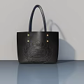 Elegant Black Leather Tote Bag With Embossed Badge And Blue Handles