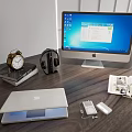 Desktop Setup With iMac Laptop Headphones Charger Books And Alarm Clock
