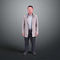 Standing Man In Light Coat And Shirt With Dark Pants Against Gray Background