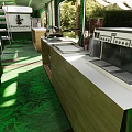 Cozy Restaurant Interior With Green Wood Grain Benches Tables And Natural Light Through Windows