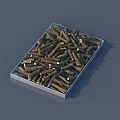 Metal tray filled with brown cut wood logs on gray background