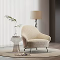 Plush Beige Accent Chair On Round Rug With Clear Acrylic Side Table And Floor Lamp