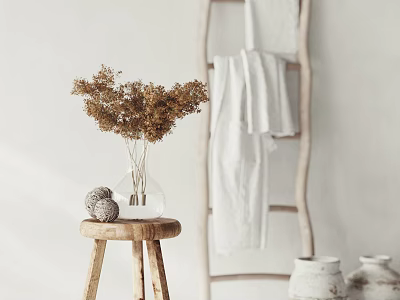Wooden Round Side Table with Clear Vase Dried Flowers Woven Ball beside Ladder White Towels 3d model