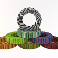 Colorful Woven Rings Stacked With Multiple Bright Colors And Intricate Patterns