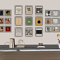 Colorful Wall Art Display with Various Prints on Beige Wall and Light Wooden Table
