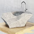 Natural Stone Washbasin In Unique Rock Shape With Chrome Faucet And Wooden Countertop