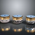 Three Decorative Storage Containers With Gold Lids White Silver Bodies And Intricate Patterns 3d model