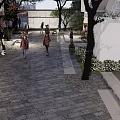 Commercial Landscape With Pedestrian Walkway Stone Pavement Trees White Buildings And Outdoor Seating