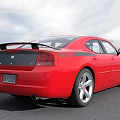 Red Sports Sedan With Black Roof Silver Alloy Wheels And Cloudy Sky