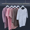 Clothes On Coat Hangers Hanging From Wooden Rod With Pink Brown And Gray Colors