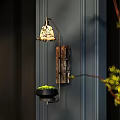 Stylish Wall Lamp with Patterned Lampshade on Dark Vertical Striped Wall and Small Potted Plant