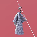 Patterned Cotton Towel Hanging On Metal Hook Against Pink Background