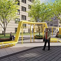Outdoor Community Recreational Area With Yellow Playground Structures Green Trees Benches And Surrounding Buildings