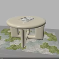 Round Cream Colored Coffee Table With Stack Of Magazines On Green White Patterned Rug 3d model