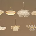 Various Petal Shaped White Chandeliers With Layered Designs And Gold Metal Accents