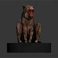 Detailed Monkey Sculpture Sitting On Black Base With Red Face And Brown Fur