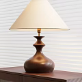 Elegant Table Lamp With Brown Base Cream Lampshade And Gold Fixture On Wooden Table
