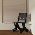 Dark Wooden Leisure Chair With Cut Out Back Design Against Light Colored Wall