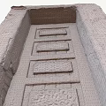 Traditional Building Exterior Wall with Intricate Carved Wooden Door and Rough Texture