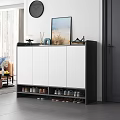 Modern Black and White Shoe Cabinet With Closed Doors Open Compartments And Decorative Top Items