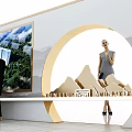 Modern Exhibition Booth Tables and Chairs with People Interacting and Display Backdrops