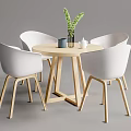 Modern Round Wooden Table With Four White Chairs Green Plant Vase Cup And Teapot