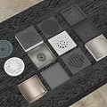 Various Metal Floor Drain Covers With Unique Designs On Dark Table 3d model