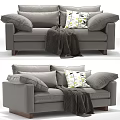 Gray Two Seater Sofa With Green Leaf Pattern Pillows Cozy Blanket And Wooden Legs