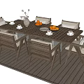 Wooden Outdoor Table With Chairs And Cushions On Deck Featuring Fruits Vase And Cups