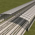 Long Covered Road Infrastructure With Transparent Roof Over Railway Tracks Surrounded By Green Grass