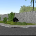 Rural Landscape with Stone Wall Green Plants Bushes and Paved Path Under Blue Sky