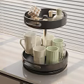 Black Two Tier Tray With Ceramic Mugs Glass Cups And Small Decorative Items