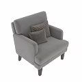 Gray Upholstered Accent Chair with Armrests and Patterned Decorative Pillows on Black Wooden Legs