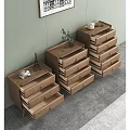 Three Wooden Dressers Against Light Green Wall With Artwork And Decor On Top