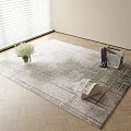 Light Gray Plaid Square Rug on Wooden Floor with White Bouquet Magazines and Dark Clothing